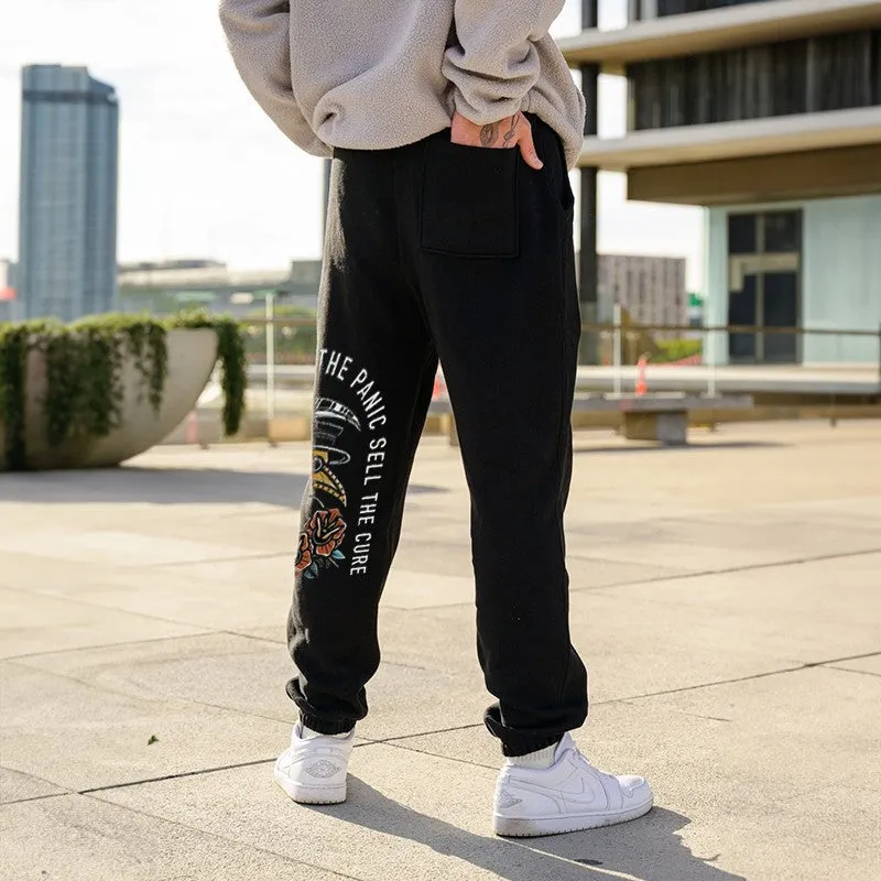 The Same Ones Who Sell The Panic Sell The Cure GRAPHIC PRINT JOGGERS